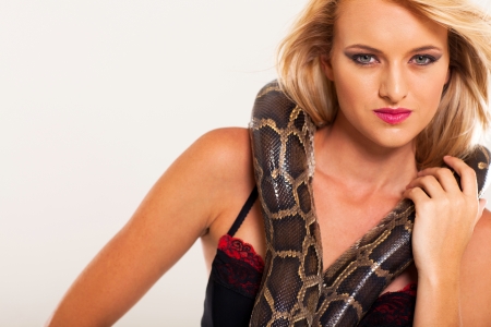 young fashion woman posing with snakeの写真素材