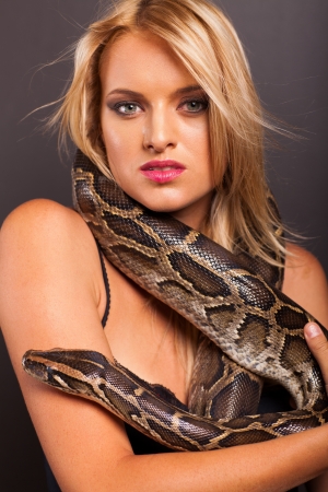attractive young woman with python around her neckの写真素材