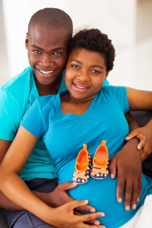 happy young african american parents to be at homeの写真素材