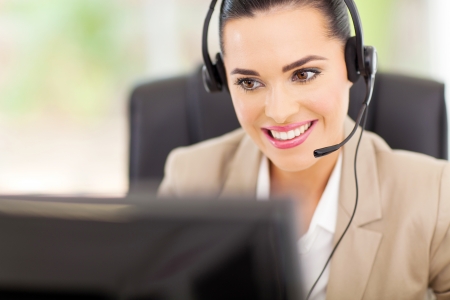 pretty female support center operator with headsetの写真素材
