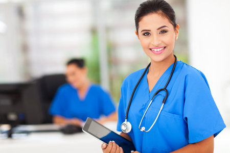attractive young female nurse holding tablet computer at workplace attractive young female nurse holding tablet computer at workplace
