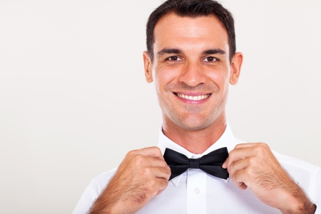 handsome waiter holding bow tie closeupの写真素材