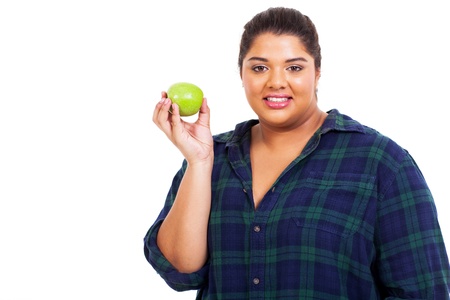 portrait of large woman holding an apple over white backgroundの写真素材
