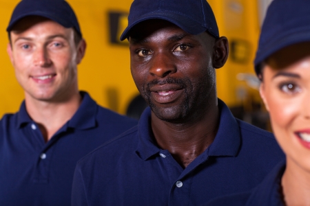 close up portrait of afro american auto technician with colleaguesの写真素材