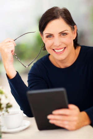portrait of senior woman holding tablet computerの写真素材