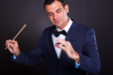 male conductor on black background