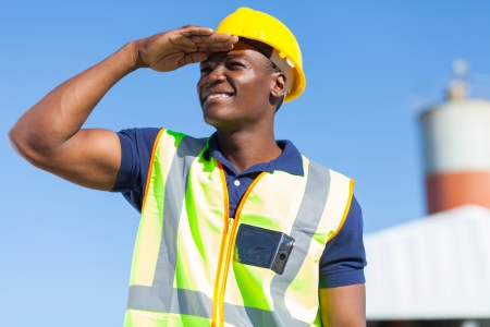 smiling african builder looking into distanceの写真素材