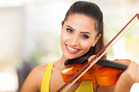 portrait of beautiful female musician playing violinの写真素材