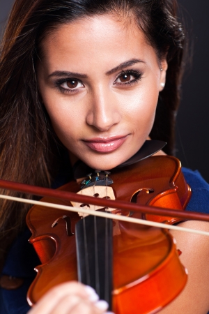 portrait of beautiful violinist over black backgroundの写真素材