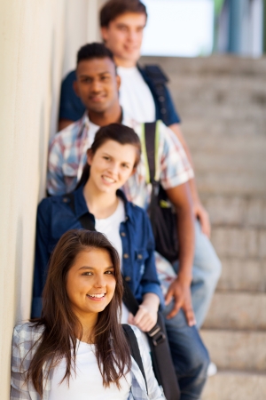 group of highschool girls and boys standing by corridor