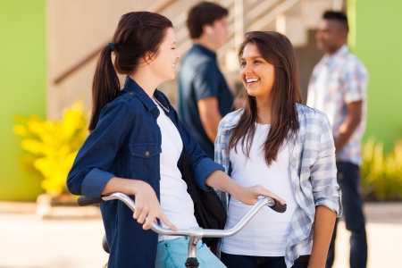 cheerful teenage friends girls talking outdoorsの写真素材
