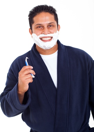smiling indian man shaving face isolated on white backgroundの写真素材