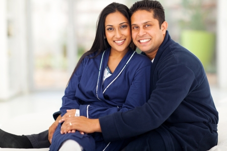 beautiful loving indian couple sitting in bedroom の写真素材