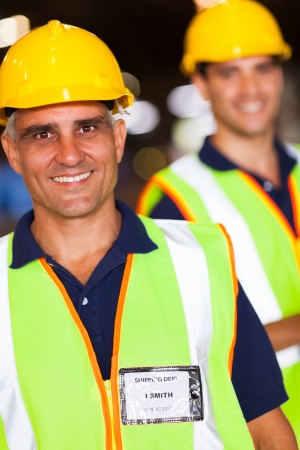 two happy shipping and warehouse worker portraitの写真素材