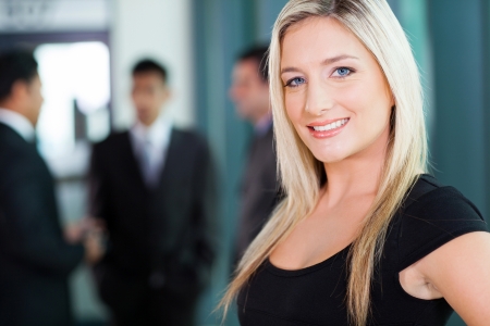 beautiful young businesswoman closeup portrait in officeの写真素材