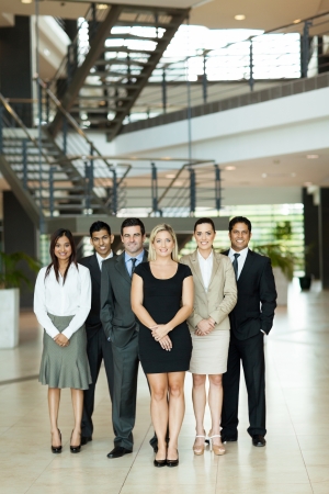 full length portrait of group business people in modern officeの写真素材