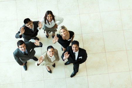 overhead view of businesspeople looking up and wavingの写真素材