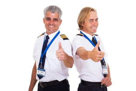 happy airline pilots giving thumbs up isolated on whiteの写真素材