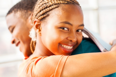 beautiful young african girl hugging her boyfriendの写真素材