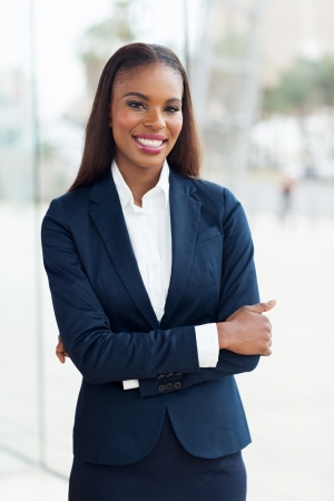 portrait of beautiful young african businesswoman with arms foldedの写真素材