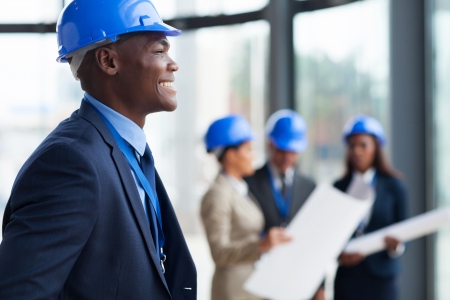 smiling african american construction worker in officeの写真素材