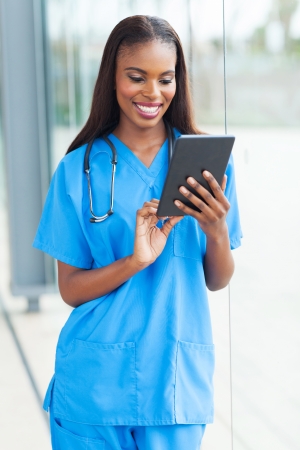 cheerful african doctor using tablet computer の写真素材