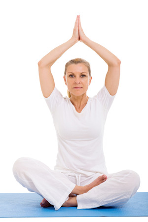 senior woman yoga meditating over white backgroundの写真素材