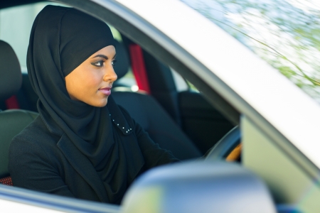 attractive young muslim woman driving a carの写真素材