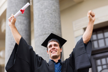 successful male university graduate after graduationの写真素材