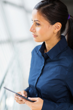 thoughtful businesswoman holding tablet computerの写真素材