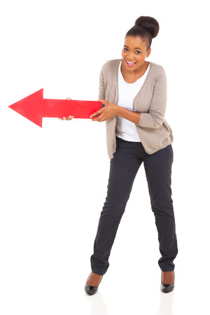 african american woman holding red arrow pointing to leftの写真素材