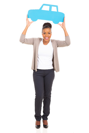 happy african woman holding paper car and looking at cameraの写真素材