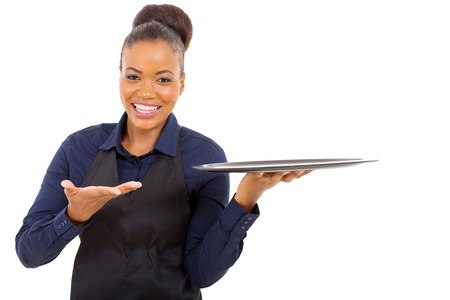 cheerful afro american waitress holding empty tray over white backgroundの写真素材
