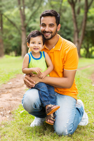 happy indian father and son outdoors in forestの写真素材