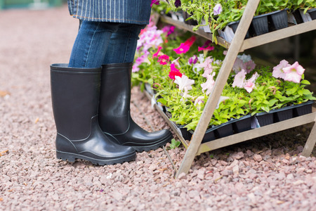 gardener wearing gumboots working in nursery