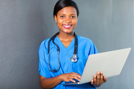 attractive african american female nurse using laptopの写真素材