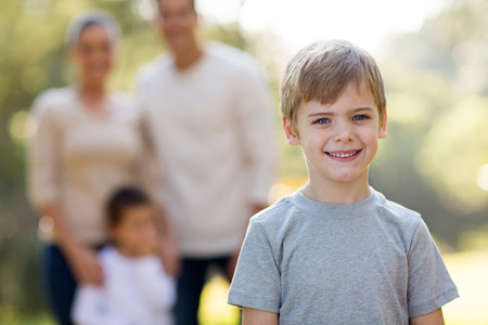 cute little boy in front of family outdoorsの写真素材