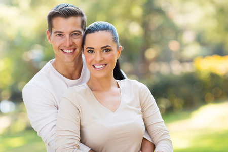 close up portrait of couple hugging outdoorsの写真素材