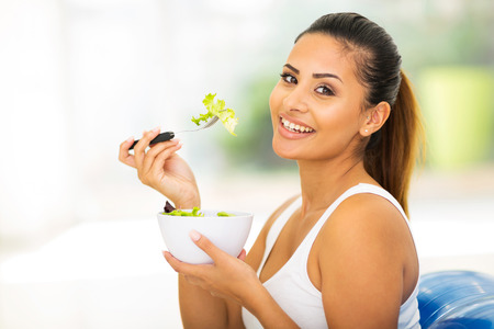 pretty woman eating healthy food at homeの写真素材