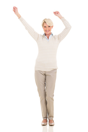 happy middle aged woman dancing on white backgroundの写真素材