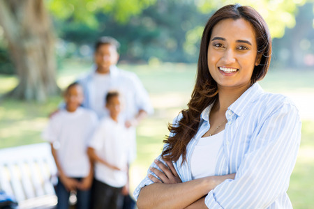gorgeous indian woman standing in front of family outdoorsの写真素材