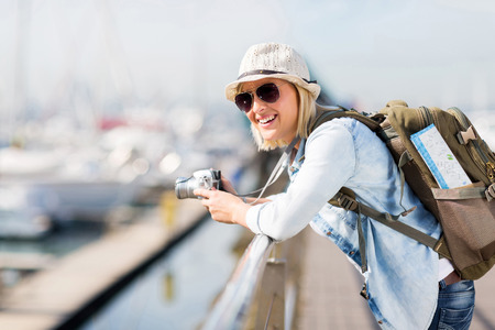gorgeous young female traveller at the harbourの写真素材