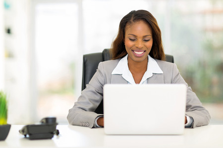pretty afro american businesswoman using laptop computerの写真素材