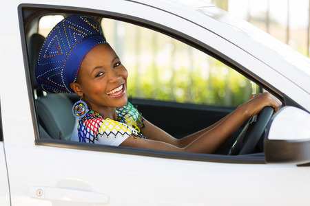 beautiful young african woman driving a car