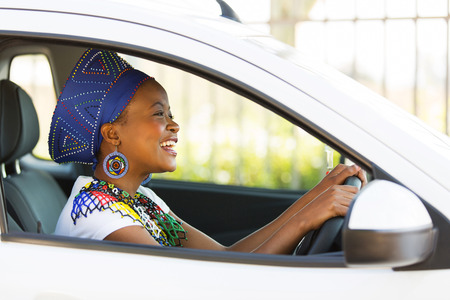 cheerful african female driver inside a carの写真素材