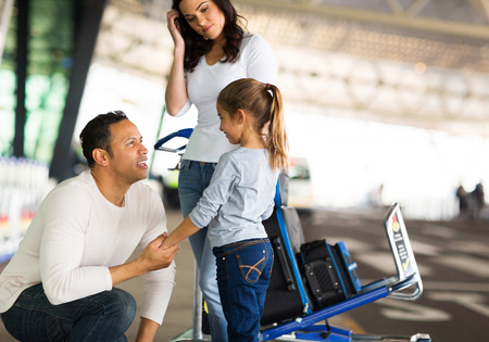 travelling man talking to her daughter at airport before departureの写真素材