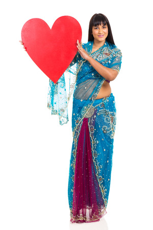 beautiful indian woman presenting heart shape isolated on whiteの写真素材