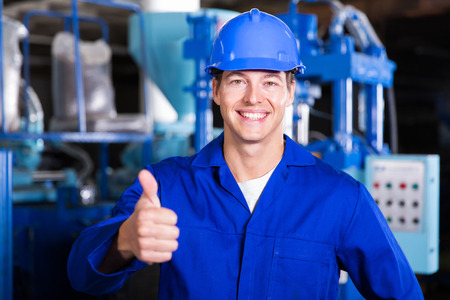 portrait of factory worker giving thumb upの写真素材