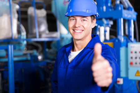 cheerful worker thumb up in factory cheerful worker thumb up in factory