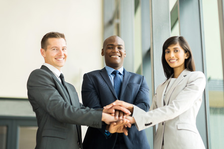 happy multiracial business team putting hands togetherの写真素材